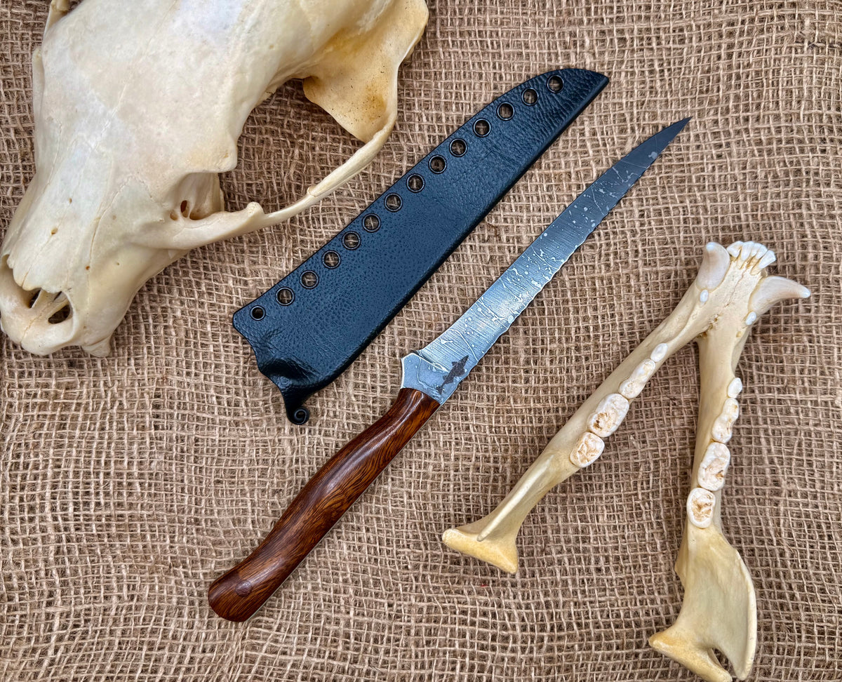 The Reef 7" fillet knife with desert ironwood handle and black textured kydex sheath