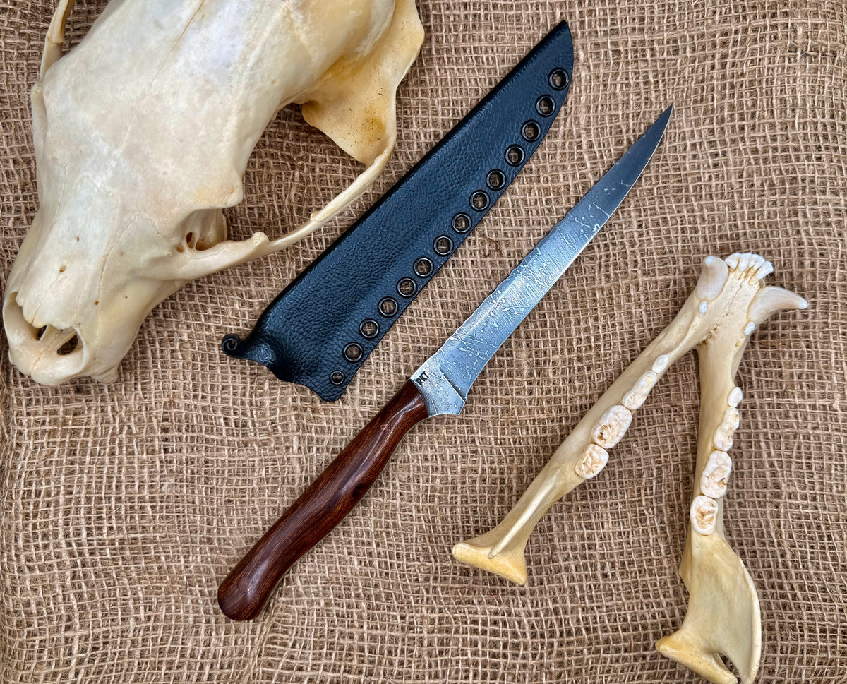 The Reef 7" fillet knife with RKT stamp and kydex sheath on burlap